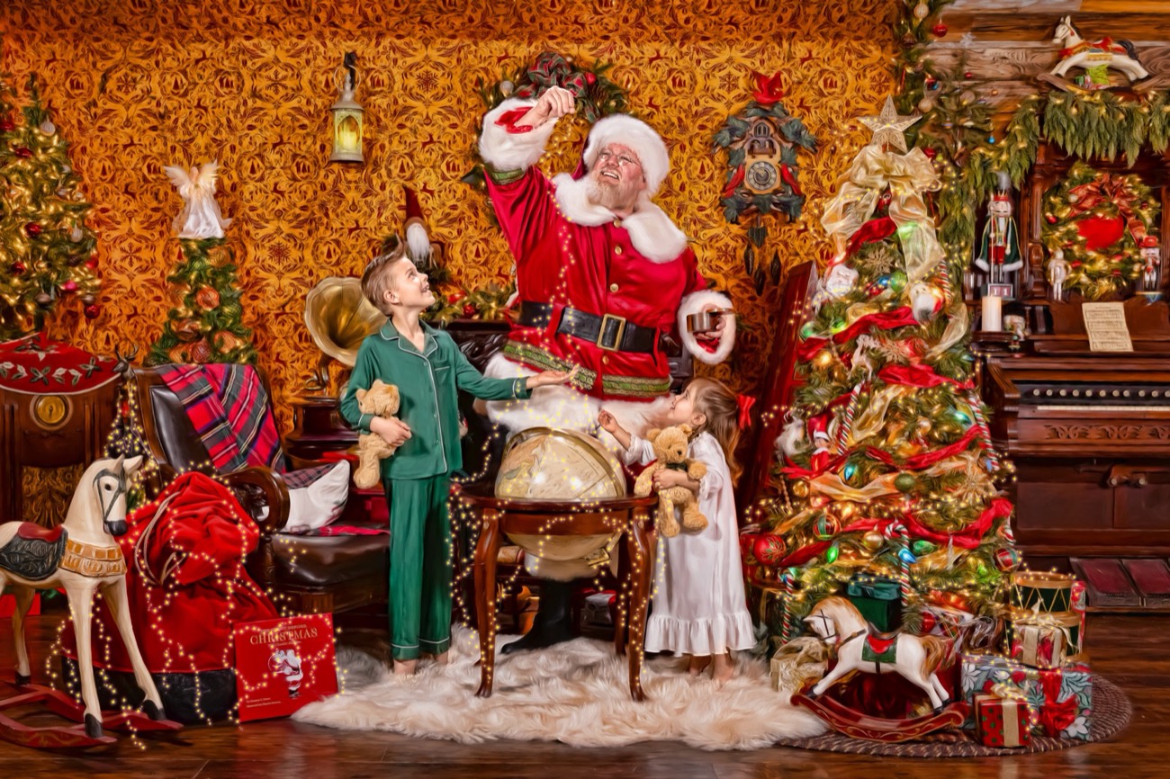 Santa and a child at the globe he uses to plan his Christmas Eve journey