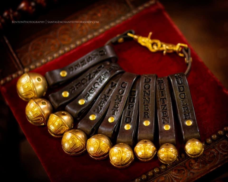 Reindeer sleigh bells on leather straps, each stamped with a reindeer's name