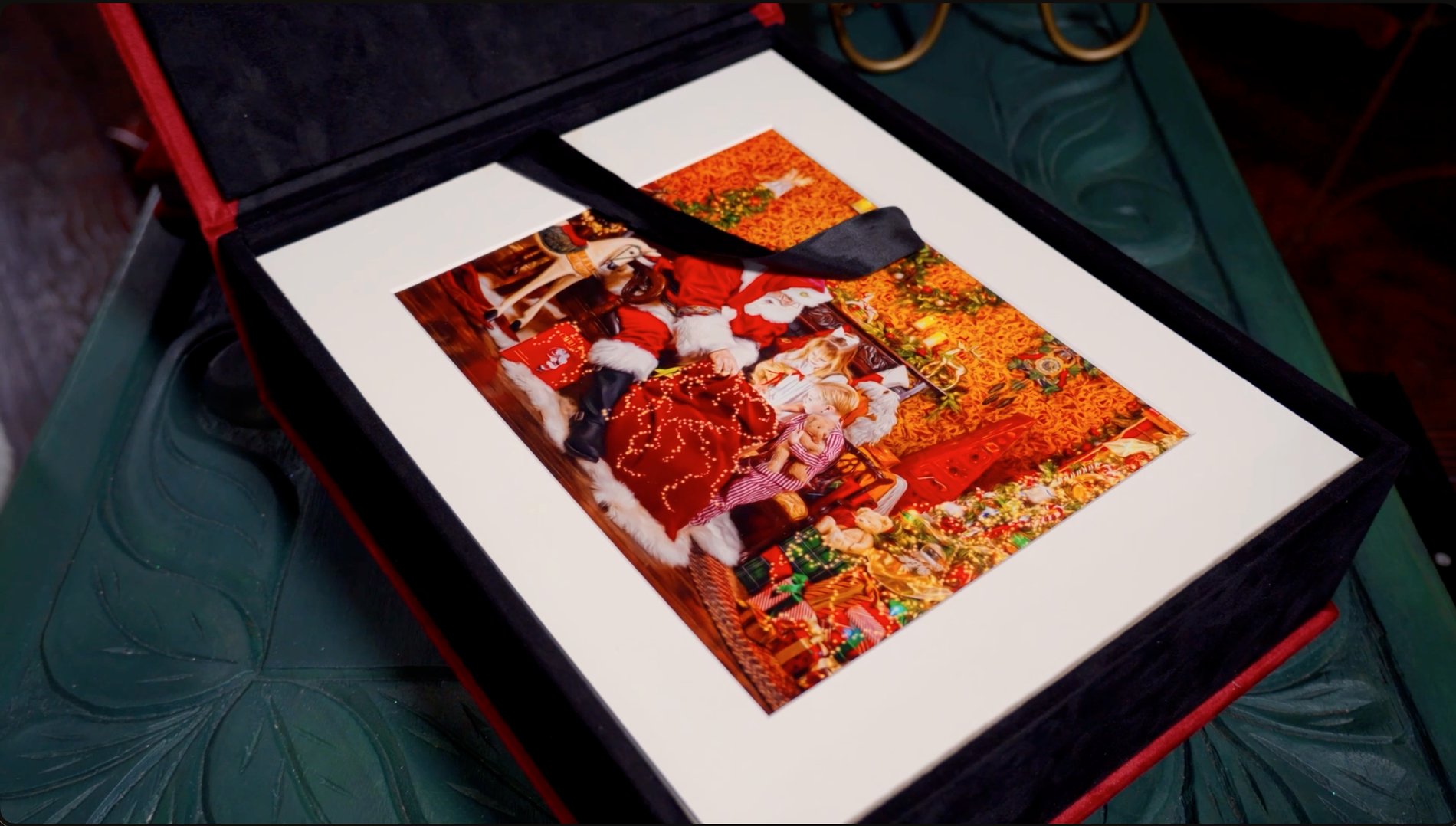 A velvet folio presentation box holding a matted fine-art print of the visit