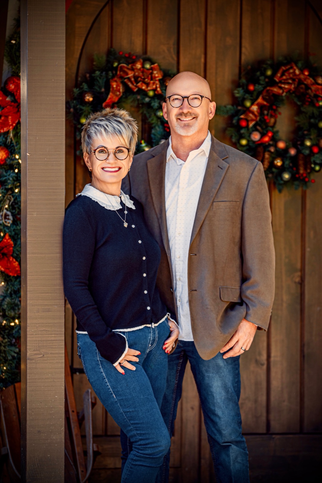 Sharon and Scot standing together in front of the workshop doors